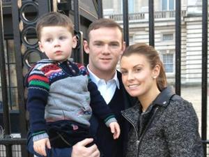 Coleen Rooney, Wayne Rooney and Kai Rooney outside Buckingham Palace
