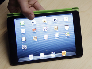 The iPad Mini, at left, is shown next to the 4th Generation iPad