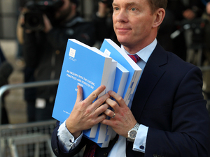 Chris Bryant MP carries copies of Lord Justice Leveson's Report from the Inquiry into the Culture, Practices and Ethics of the Press, at the QEII Conference Centre, in central London.