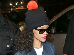 Rihanna arriving back at her hotel wearing a black hat with an orange bobble.
London, England - 26.11.12
