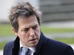 British actor Hugh Grant, who testified to the Leveson Inquiry, arrives at the Queen Elizabeth II Conference Centre in London where Lord Justice Brian Leveson is to release his report
