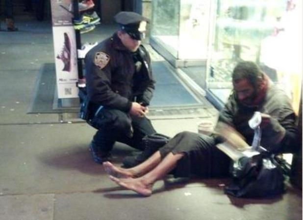 Police officer gives shoes to homeless man