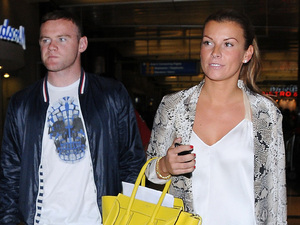 Wayne Rooney and Coleen Rooney
arrive at LAX on a flight from London
Los Angeles, California - 26.06.12