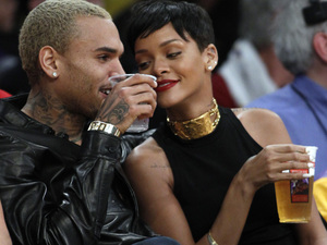 Entertainers Chris Brown, left, and Rihanna attend an NBA basketball game between the Los Angeles Lakers and New York Knicks in Los Angeles, Tuesday, Dec. 25, 2012. The Lakers won 100-94. (AP Photo/Alex Gallardo)