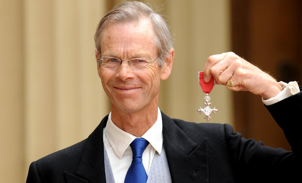 Cricket commentator and writer Christopher Martin Jenkins poses outside Buckingham Palace with his MBE