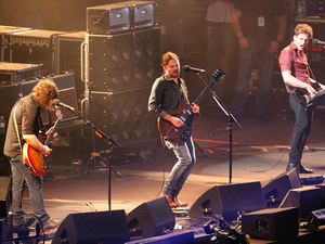 Kings of Leon's Nathan Followill (left), Caleb Followill (centre) and Jared Followill (right) in concert at Murrayfield Stadium in Edinburgh.