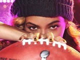 Beyoncé poses with football to promote her upcoming Super Bowl performance