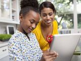 Mother and daughter using tablet computer