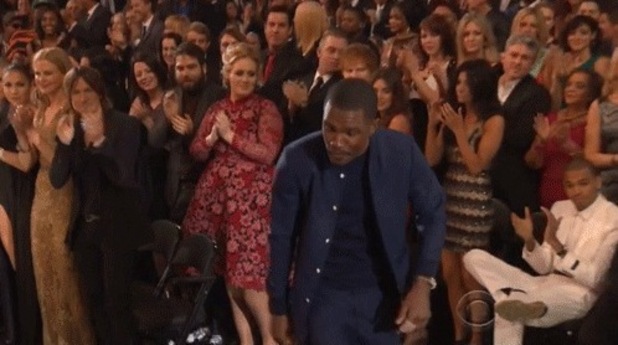 Adele looks over at Chris Brown, who fails to stand when Frank Ocean gets a standing ovation.