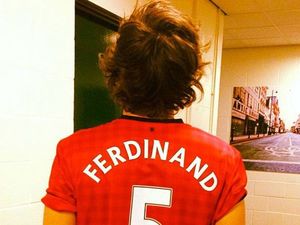 Harry Styles wears Rio Ferdinand's Manchester United shirt.
