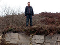 David stands on the edge of a cliff