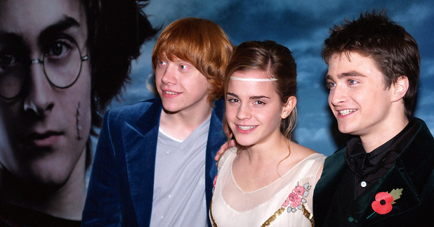 Daniel Radcliffe, right, actress Emma Watson, and Rupert Grint, left, stand in front of the film's poster, in London's Leicester Square for the premier of their latest Harry Potter film, 'Harry Potter and the Goblet of Fire, 2005