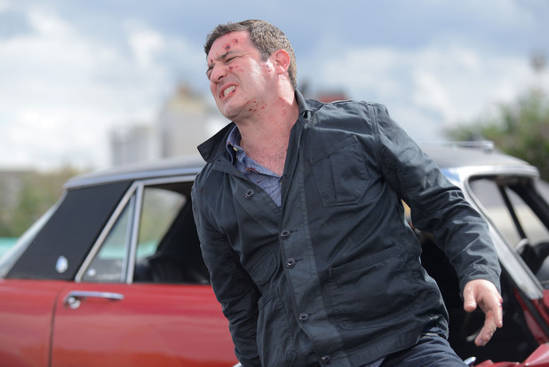 Carl moves away from the wreckage.