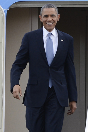 President Barack Obama smiles upon arrival on Air Force One at Berry Field Tennessee Air National Guard 118th Airlift Wing on Thursday, Jan. 30, 2014, in Nashville, Tenn. Obama is in Nashville to speak at McGavock High Schoo