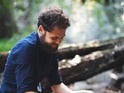 Mike Rosenberg walks through a forest in the video for his latest single.