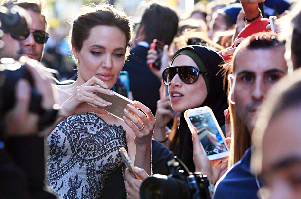SYDNEY, AUSTRALIA - NOVEMBER 17: Angelina Jolie greets fans at the 'Unbroken' premiere on November 17, 2014 in Sydney, Australia. (Photo by KHAP/GG/GC Images)
