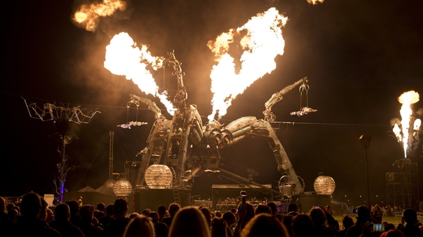 Revellers watch the Arcadia pyrotechnic show at the Glastonbury Festival 2015