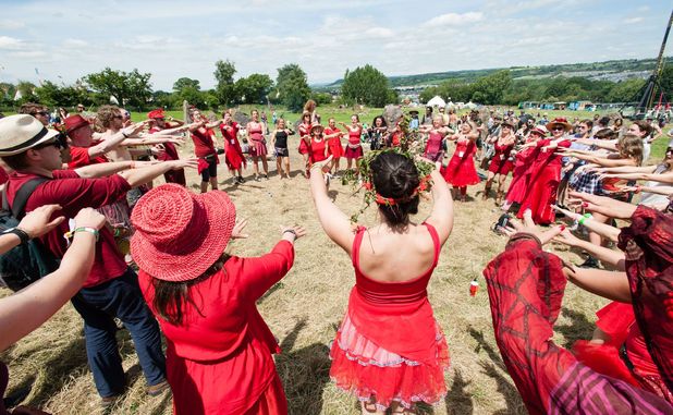 Members of the Shakti Choir conduct an opening ceremony at the Stone Circle at Glastonbury Festival 2015